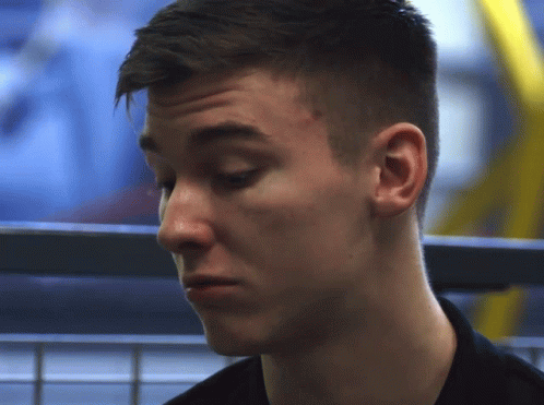 A Close Up Of A Young Man 'S Face With A Serious Look On His Face GIF