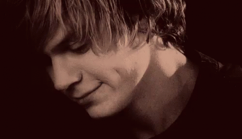 A Close Up Of A Young Man 'S Face With A Serious Look On His Face In A Black And White Photo . GIF