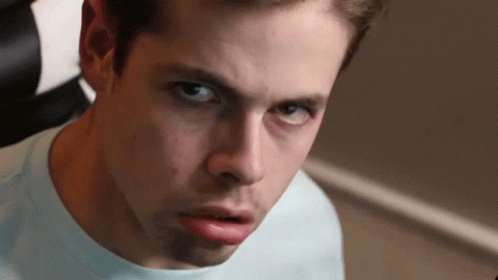 A Close Up Of A Young Man 'S Face With A Serious Look On His Face GIF