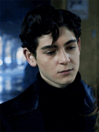 A Close Up Of A Young Man 'S Face With A Sign In The Background That Says No Smoking GIF