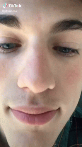 A Close Up Of A Young Man 'S Face With A Smile On His Face . GIF
