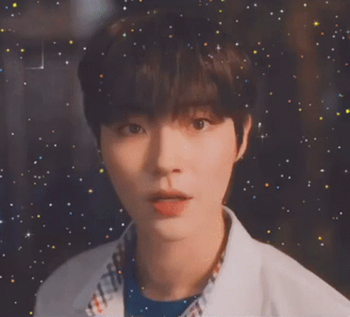 A Close Up Of A Young Man 'S Face With A Starry Background GIF