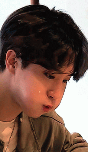 A Close Up Of A Young Man 'S Face With A Tear Coming Out Of His Nose GIF