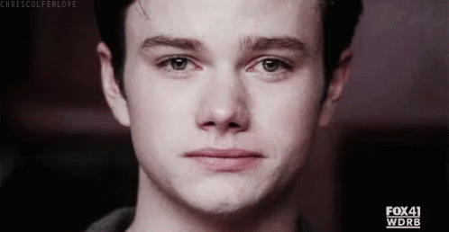 A Close Up Of A Young Man 'S Face With A Tear Running Down His Face . GIF