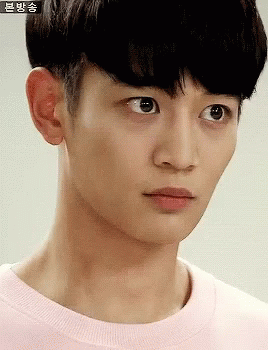 A Close Up Of A Young Man 'S Face With Chinese Writing On The Bottom GIF