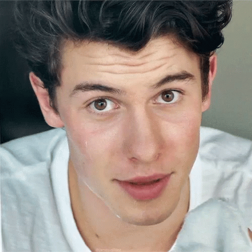A Close Up Of A Young Man 'S Face With His Eyes Closed GIF