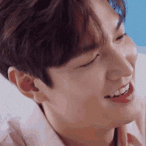 A Close Up Of A Young Man 'S Face With His Eyes Closed And His Mouth Open . GIF