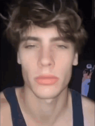 A Close Up Of A Young Man 'S Face With His Eyes Closed And His Mouth Open . GIF