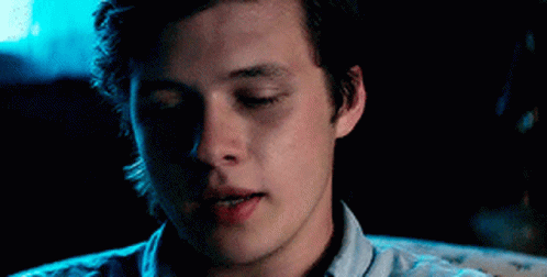 A Close Up Of A Young Man 'S Face With His Eyes Closed In A Dark Room . GIF