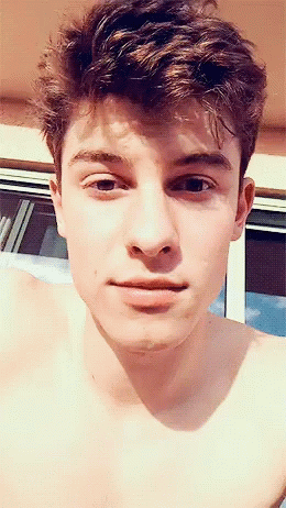 A Close Up Of A Young Man 'S Face With His Shirt Off GIF