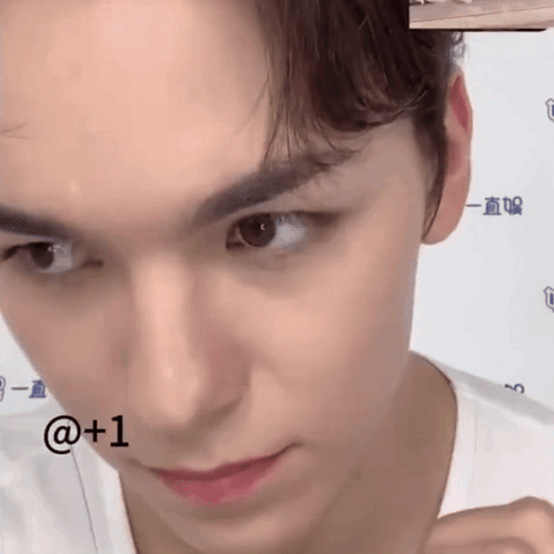 A Close Up Of A Young Man 'S Face With The Number 1 Next To His Face . GIF