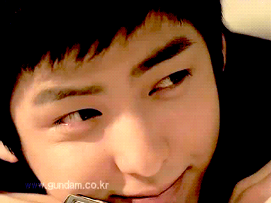 A Close Up Of A Young Man 'S Face With The Website Www.gundam.co.kr In The Background GIF
