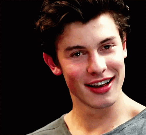 A Close Up Of A Young Man Smiling With His Mouth Open . GIF