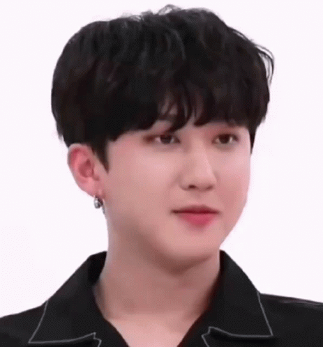 A Close Up Of A Young Man Wearing A Black Shirt And Earring . GIF