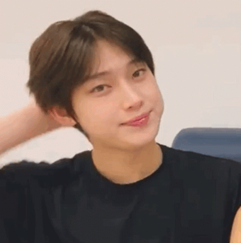 A Close Up Of A Young Man Wearing A Black Shirt Making A Funny Face . GIF
