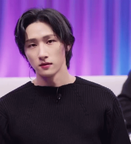 A Close Up Of A Young Man Wearing A Black Sweater And Earrings . GIF