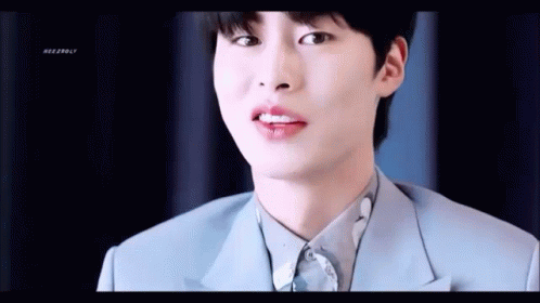A Close Up Of A Young Man Wearing A Blue Suit And White Shirt . GIF