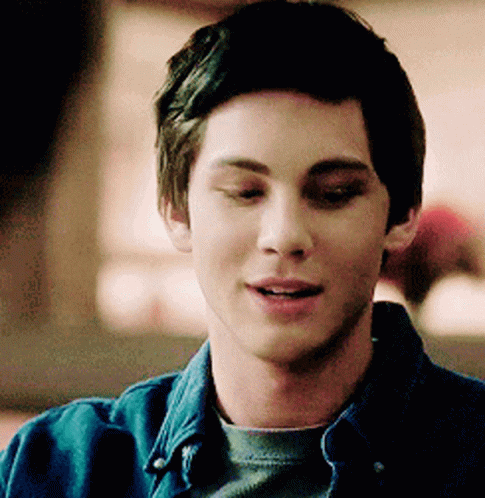 A Close Up Of A Young Man Wearing A Denim Shirt GIF