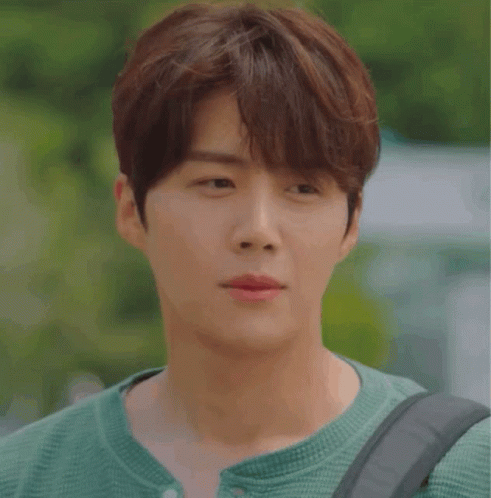 A Close Up Of A Young Man Wearing A Green Shirt GIF