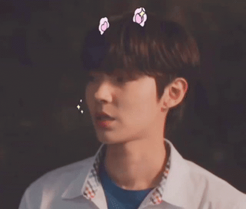 A Close Up Of A Young Man Wearing A White Shirt And A Blue Shirt With Hearts On His Head . GIF