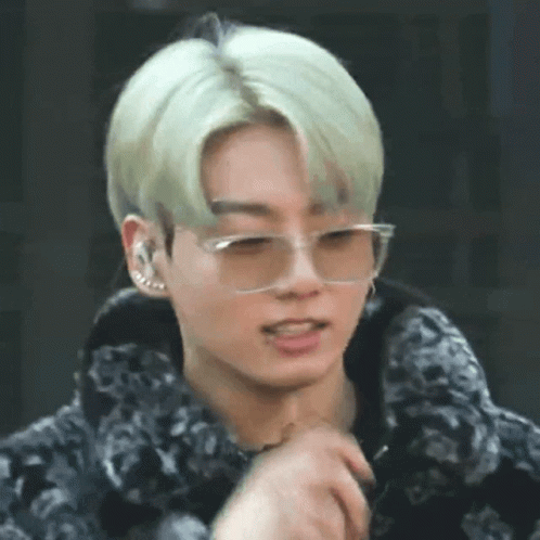 A Close Up Of A Young Man Wearing Glasses And A Fur Coat . GIF