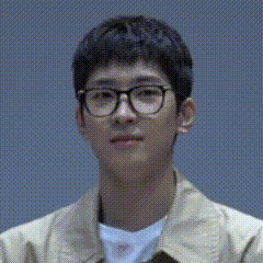 A Close Up Of A Young Man Wearing Glasses And A Jacket . GIF