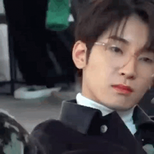 A Close Up Of A Young Man Wearing Glasses And A Suit . GIF