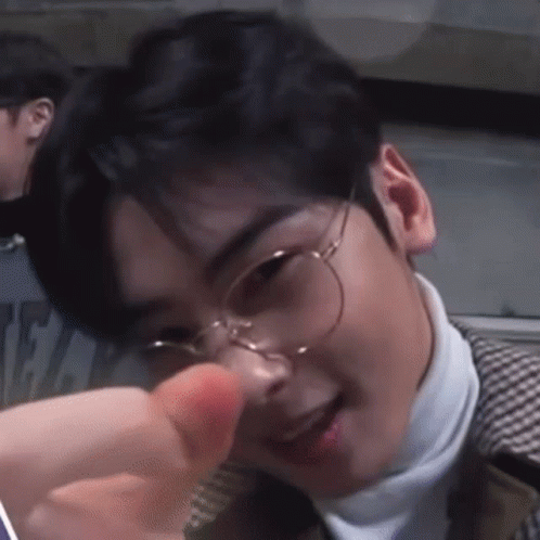 A Close Up Of A Young Man Wearing Glasses And A Turtleneck . GIF