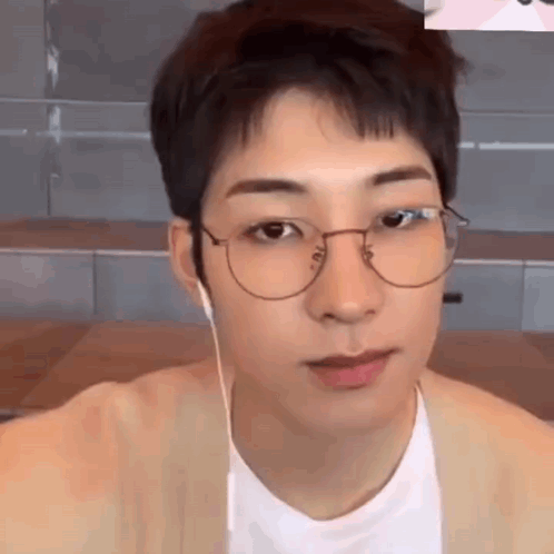 A Close Up Of A Young Man Wearing Glasses And Headphones . GIF