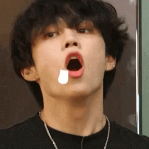 A Close Up Of A Young Man With His Mouth Open And A Tear Coming Out Of His Mouth . GIF