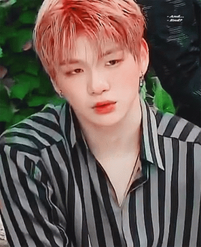 A Close Up Of A Young Man With Red Hair Wearing A Striped Shirt . GIF