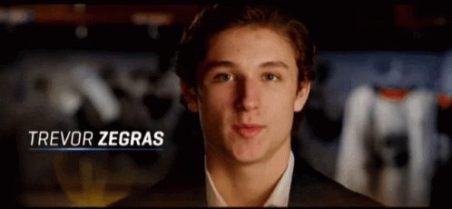 A Close Up Of A Young Man With The Name Trevor Zegras GIF
