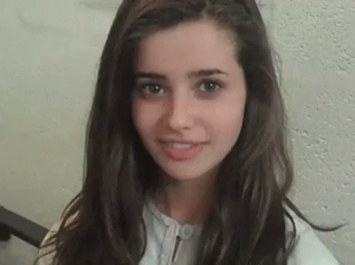 a close up of a young woman 's face with long hair .