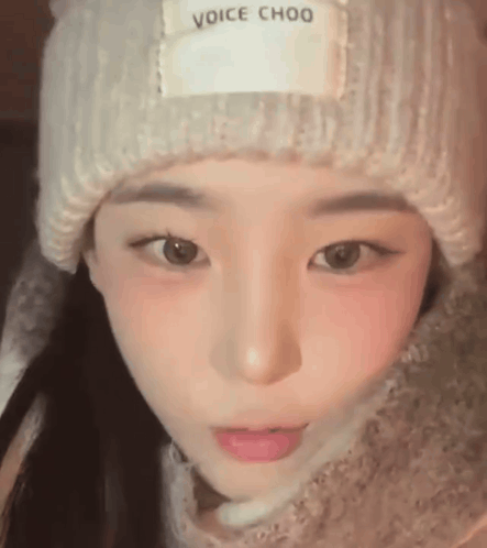 A Close Up Of A Young Woman Wearing A Hat And Scarf . GIF