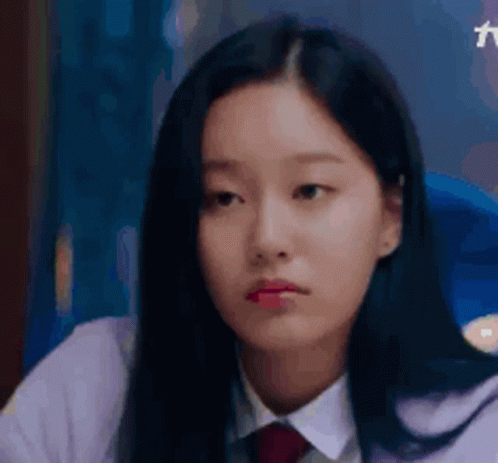 A Close Up Of A Young Woman Wearing A White Shirt And Red Tie . GIF