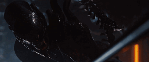 A Close Up Of An Alien With Its Mouth Open And Sharp Teeth GIF