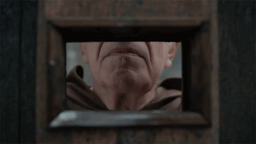 A Close Up Of An Elderly Man 'S Face With His Hand On His Mouth GIF