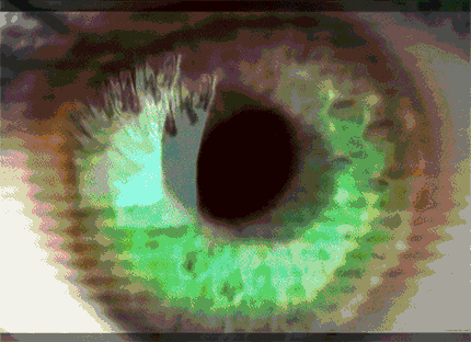 a close up of an eye with a green iris