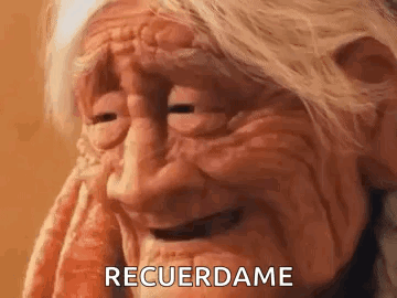A Close Up Of An Older Woman 'S Face With The Words `` Recuerdame '' Written On It . GIF