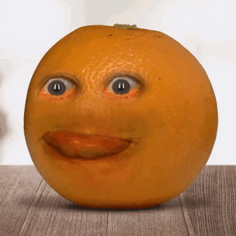 A Close Up Of An Orange With A Face On It GIF