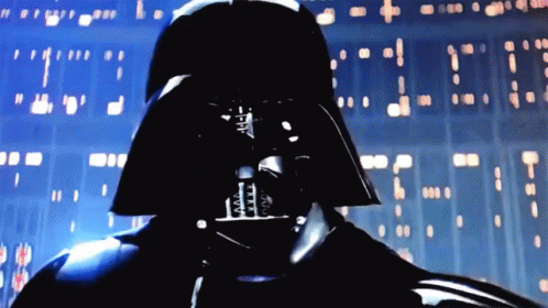 A Close Up Of Darth Vader 'S Face In Front Of A Wall GIF