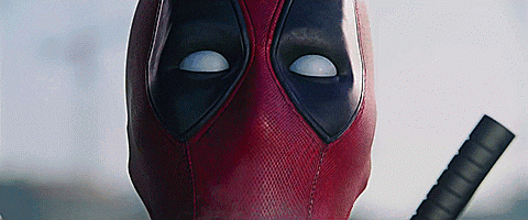 A Close Up Of Deadpool 'S Face With A Sword . GIF