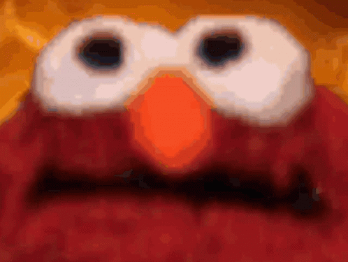 A Close Up Of Elmo 'S Face With A Blurred Background GIF