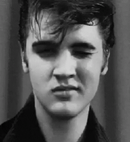 A Close Up Of Elvis Presley 'S Face In A Black And White Photo With His Eyes Closed . GIF