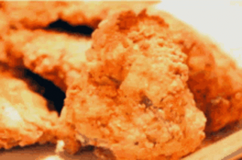 A Close Up Of Fried Chicken Pieces On A Plate GIF