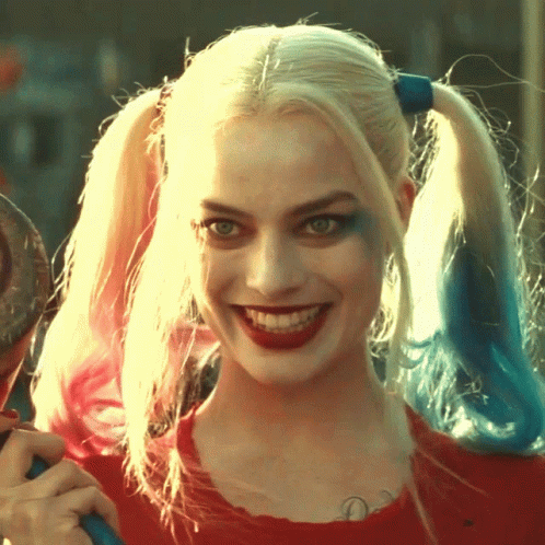 A Close Up Of Harley Quinn 'S Face With Pigtails GIF