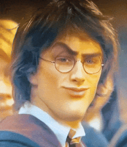 A Close Up Of Harry Potter Wearing Glasses And A Suit GIF