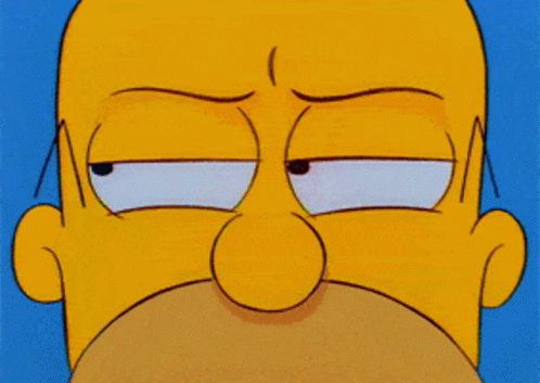 a close up of homer simpson 's face with an angry look on his face