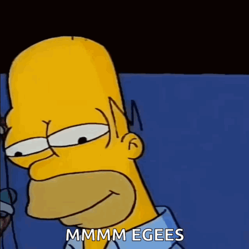 A Close Up Of Homer Simpson 'S Face With The Words Mmmm Egees Written On The Bottom GIF