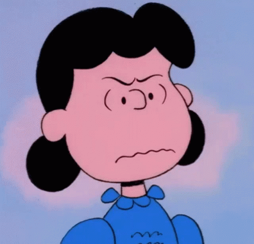 A Close Up Of Lucy Brown From The Peanuts Showing An Angry Look On Her Face GIF